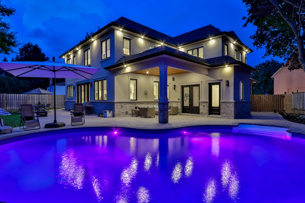 white concrete building near swimming pool during night time