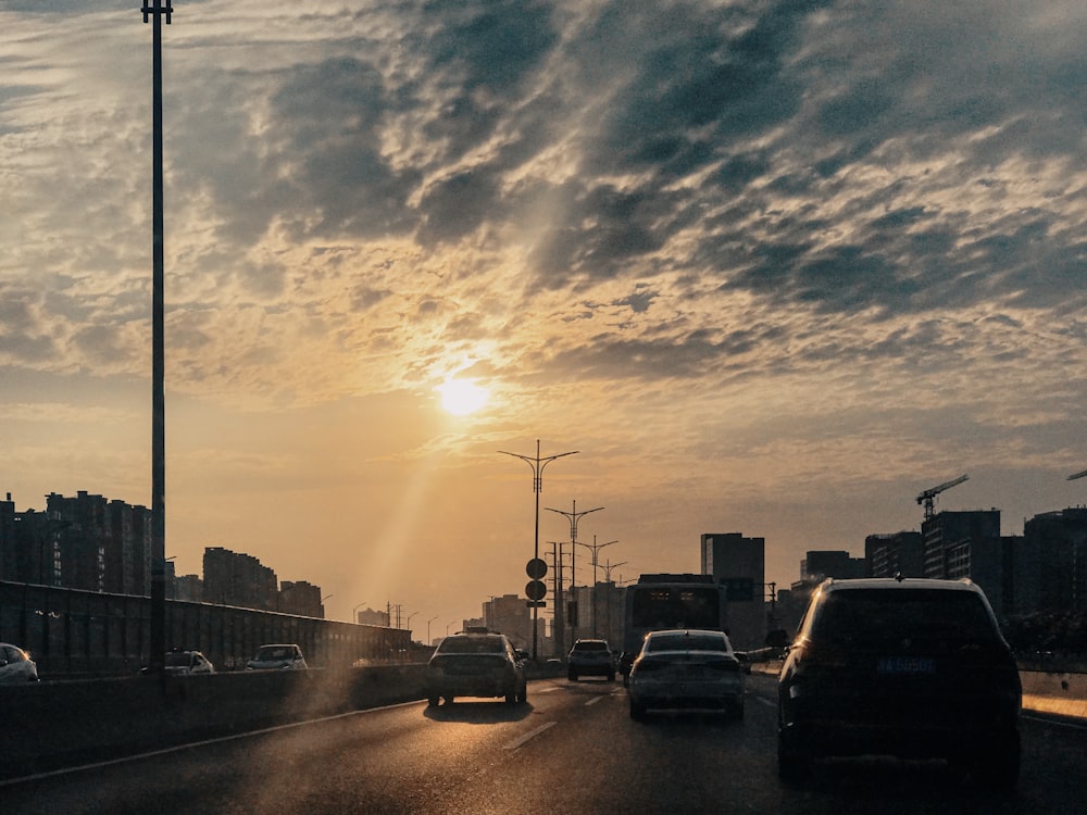 cars on road during sunset