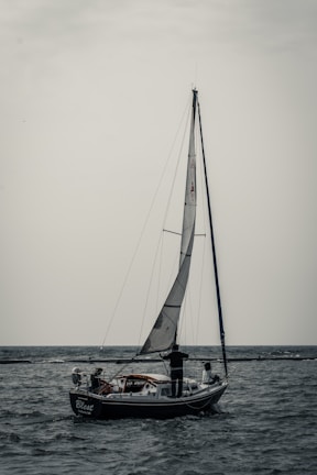 white sail boat on sea during daytime