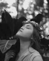 Relaxed woman enjoying a moment of wellness with a tropical flower crown.