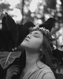 Relaxed woman enjoying a moment of wellness with a tropical flower crown.