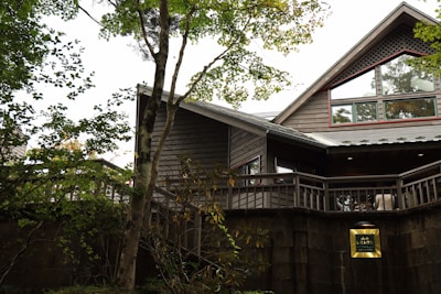 A modern wooden house with large windows blending traditional Japanese and Scandinavian design elements.