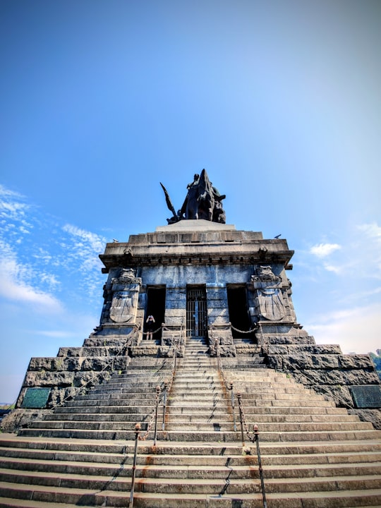 black bird on top of gray concrete building in Deutsches Eck Germany