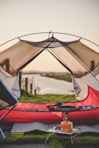 red and white tent on green grass field during daytime