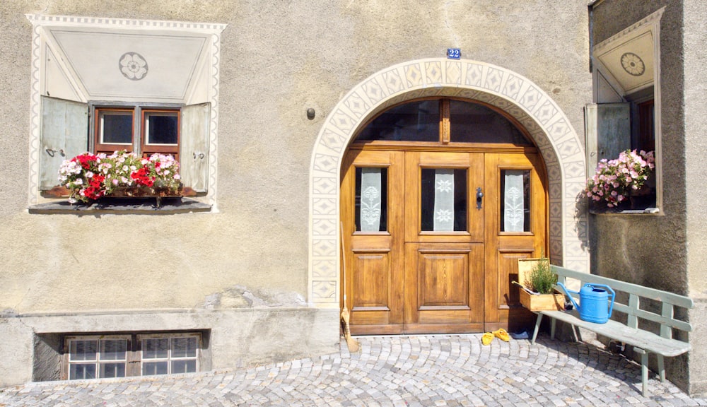 brown wooden door on white concrete building