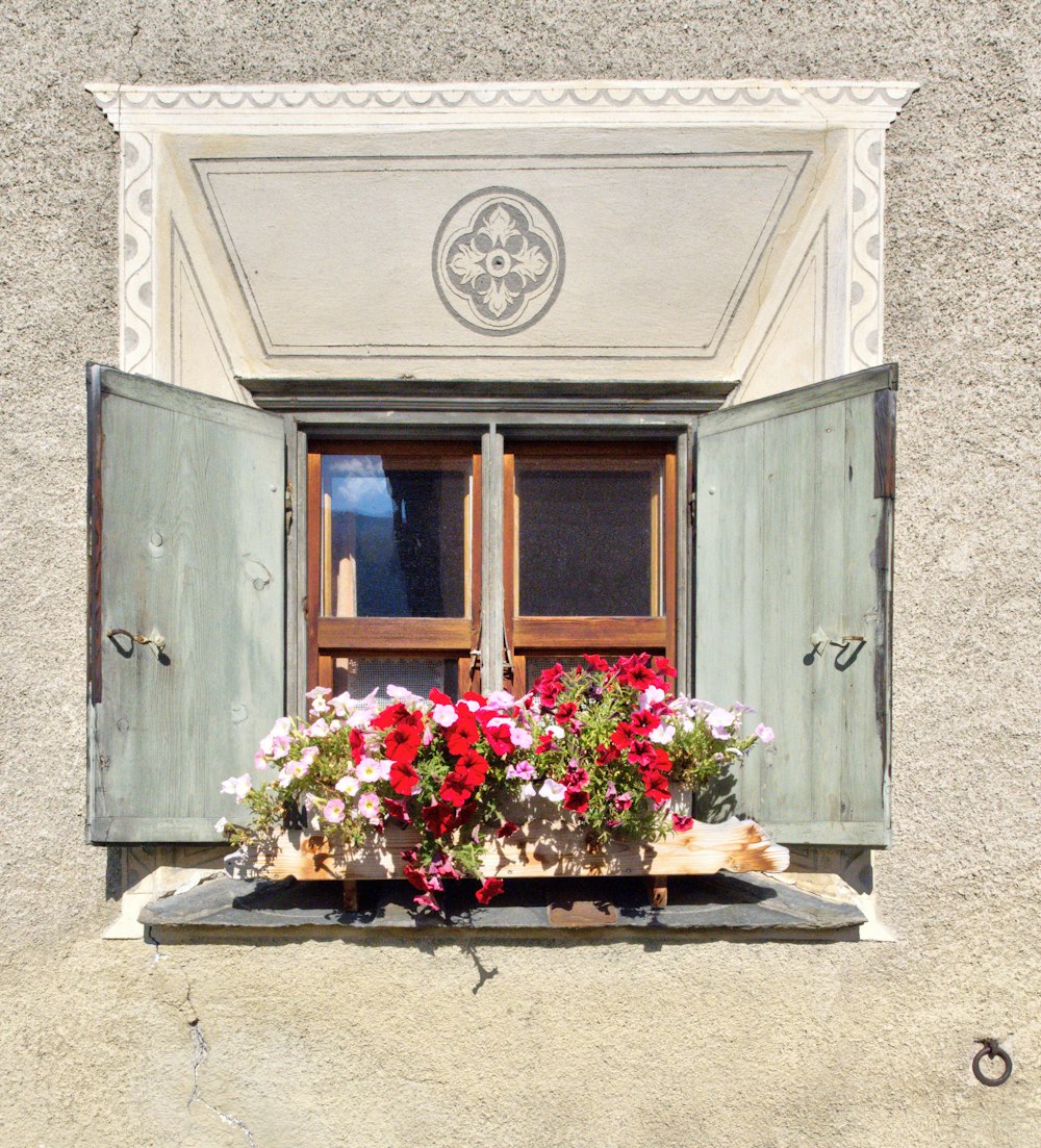 blue wooden door with flowers on top