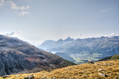 A panoramic view of a mountain ridge with a bustling hill station promenade.