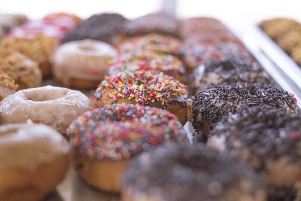 assorted doughnuts on brown wooden tray