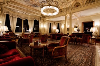 An elegantly arranged room with soft lighting and luxurious fabrics, creating an inviting atmosphere for intimate experiences.