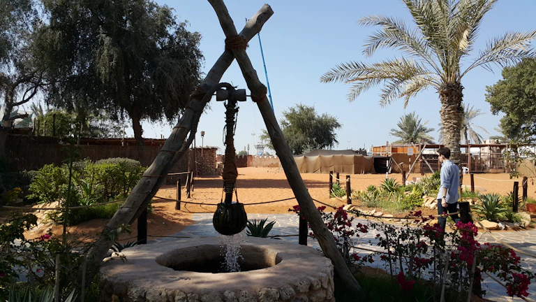 A clean, professional deep well pump installed on a Syrian farm under bright sunlight.