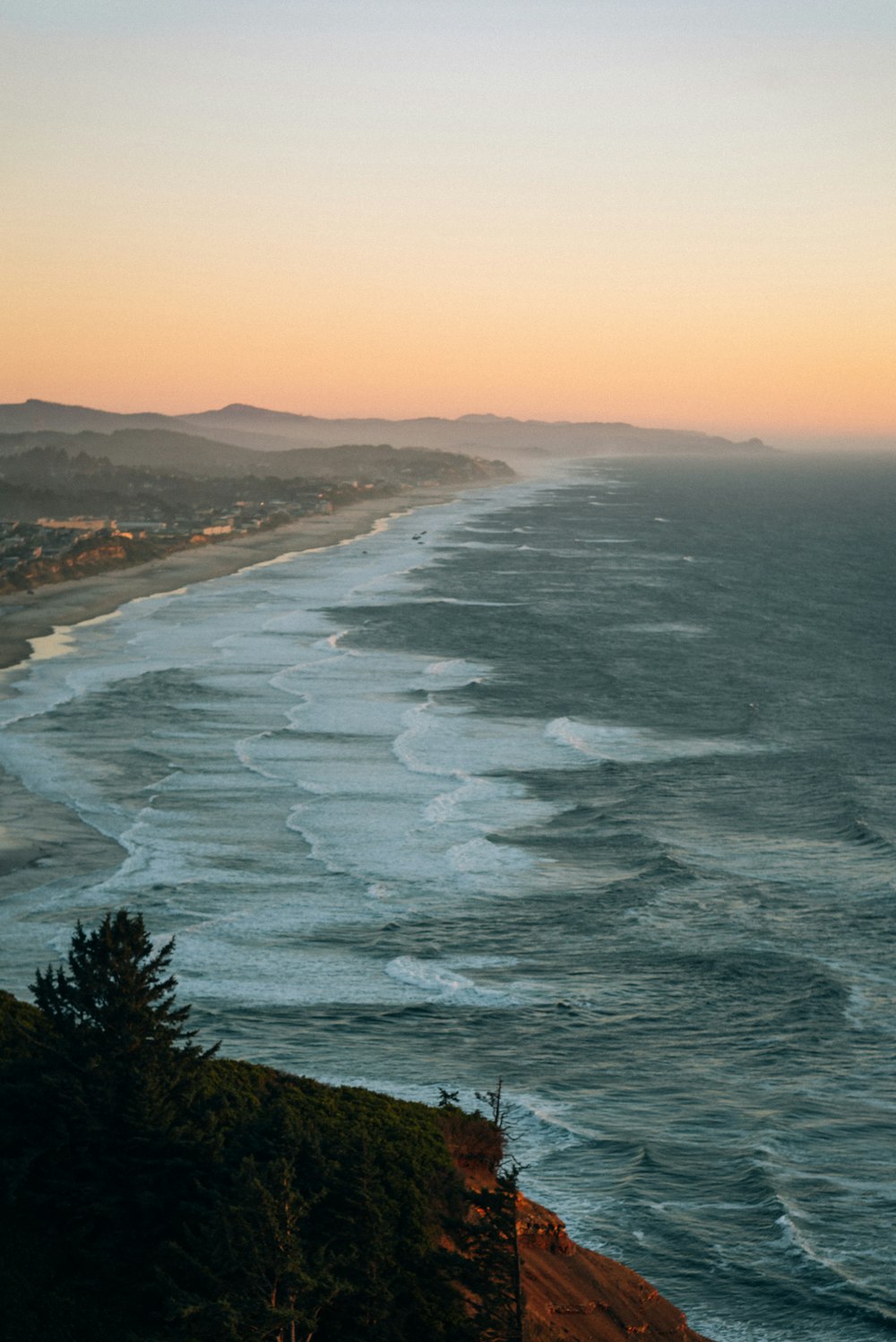 aerial view of sea waves crashing on shore during daytime