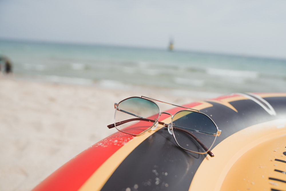 yellow and red surfboard on beach during daytime