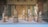 A beautifully arranged display of intricate wooden and marble statues on a velvet backdrop.