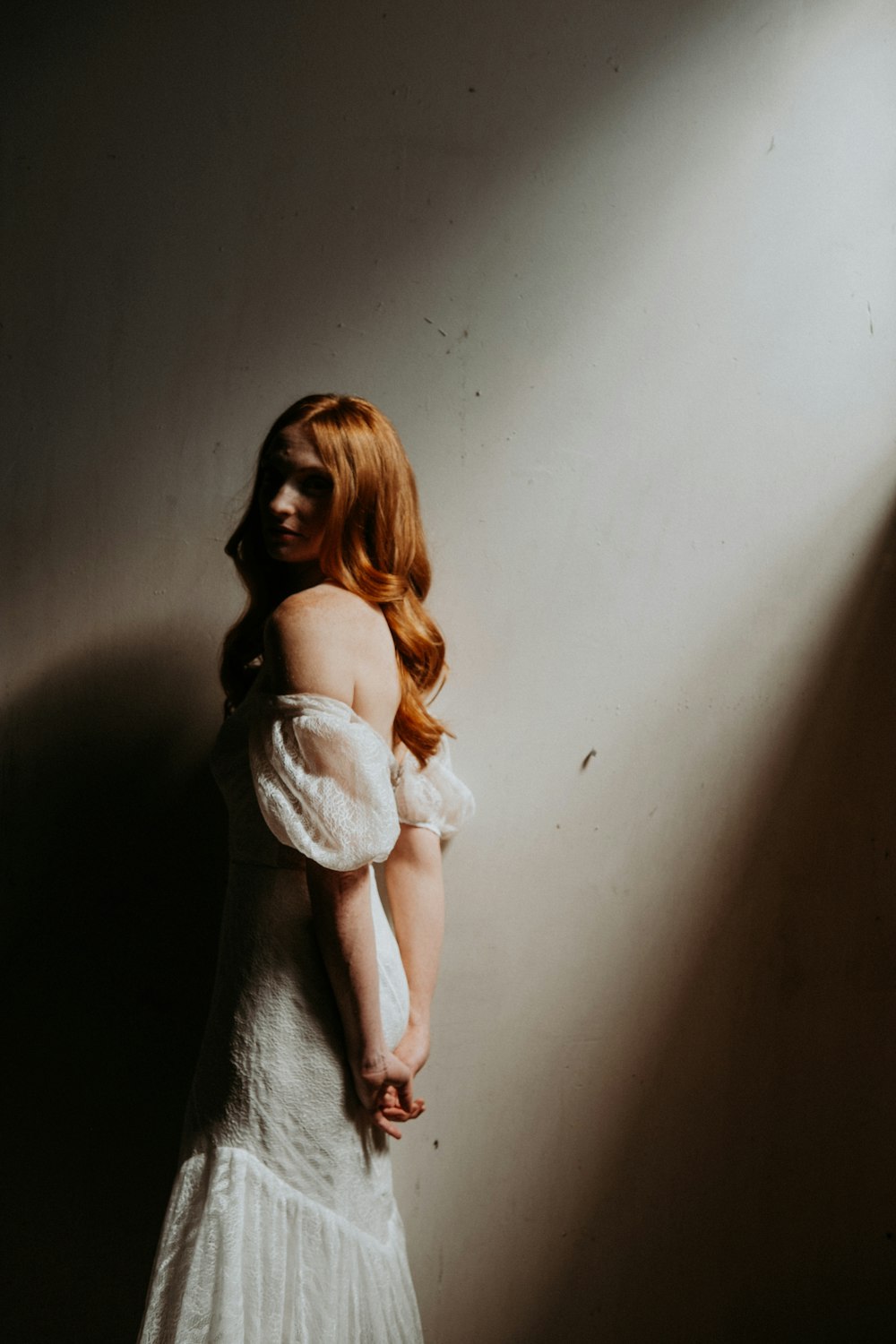 woman in white dress holding white textile