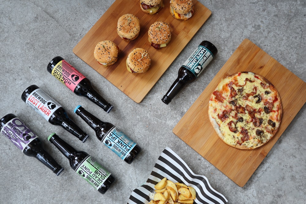 black and green labeled bottle beside brown wooden chopping board