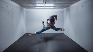 A dynamic figure performing parkour moves on various obstacles inside a covered training area