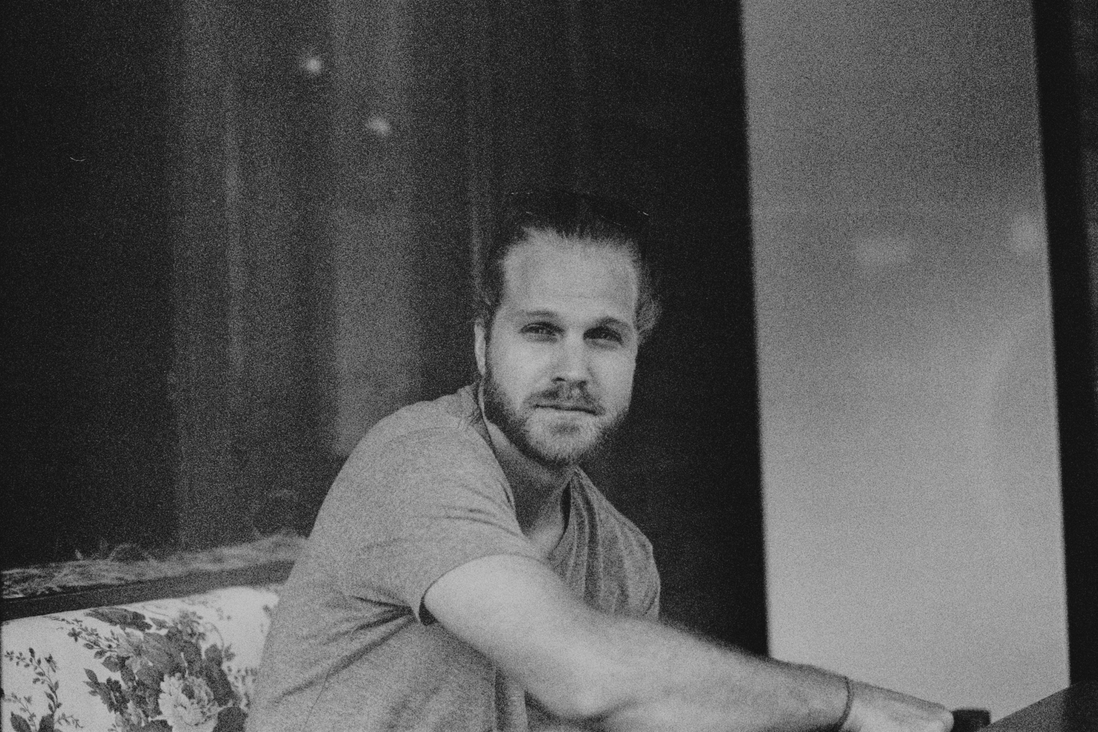 man in gray t-shirt smiling