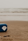 blue and white surfboard on beach during daytime