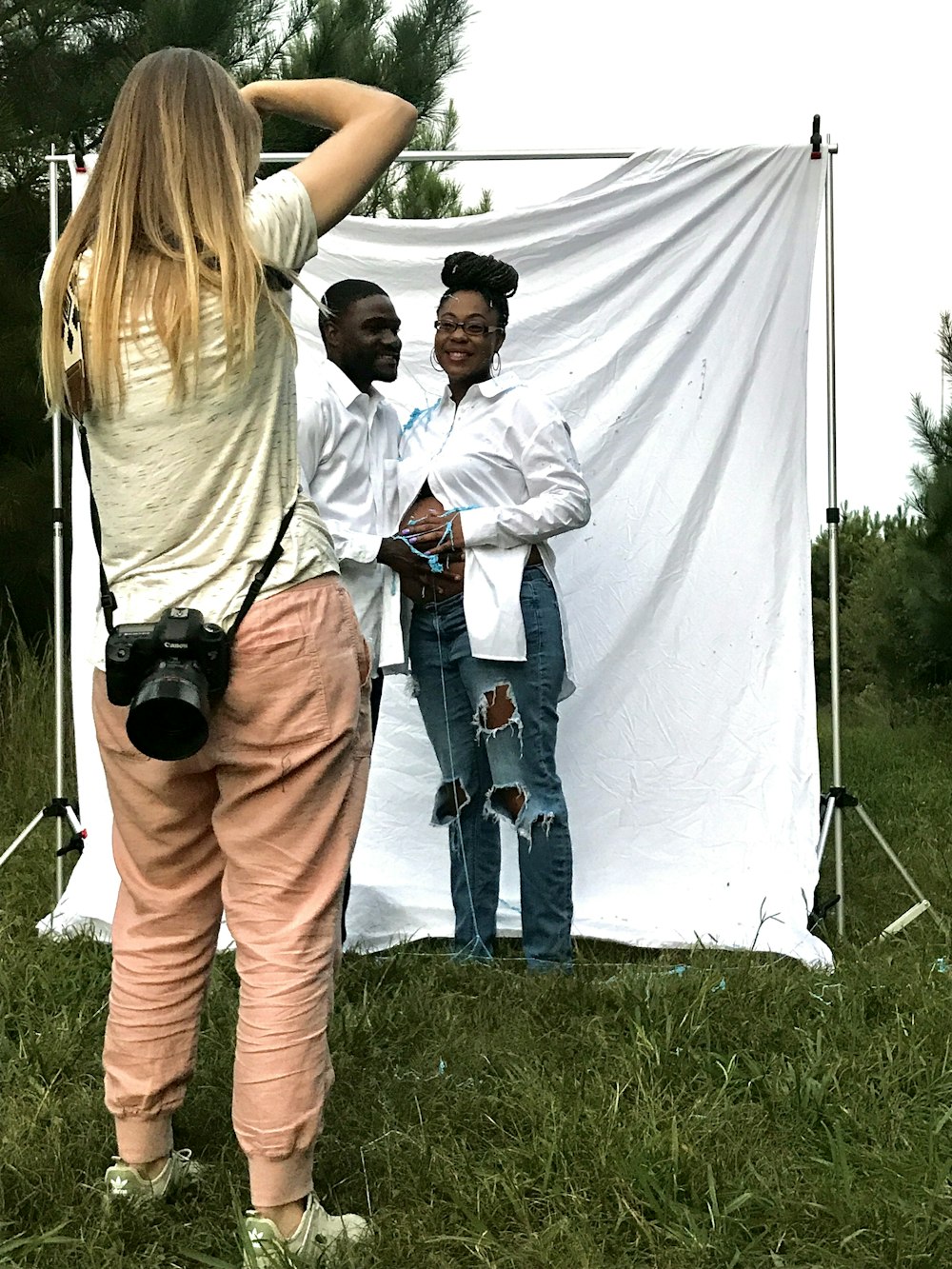 woman in white long sleeve shirt holding black dslr camera