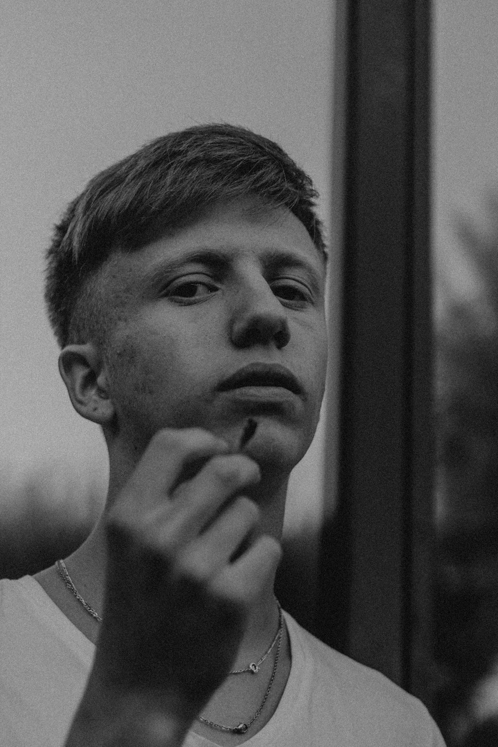 grayscale photo of man in white crew neck shirt