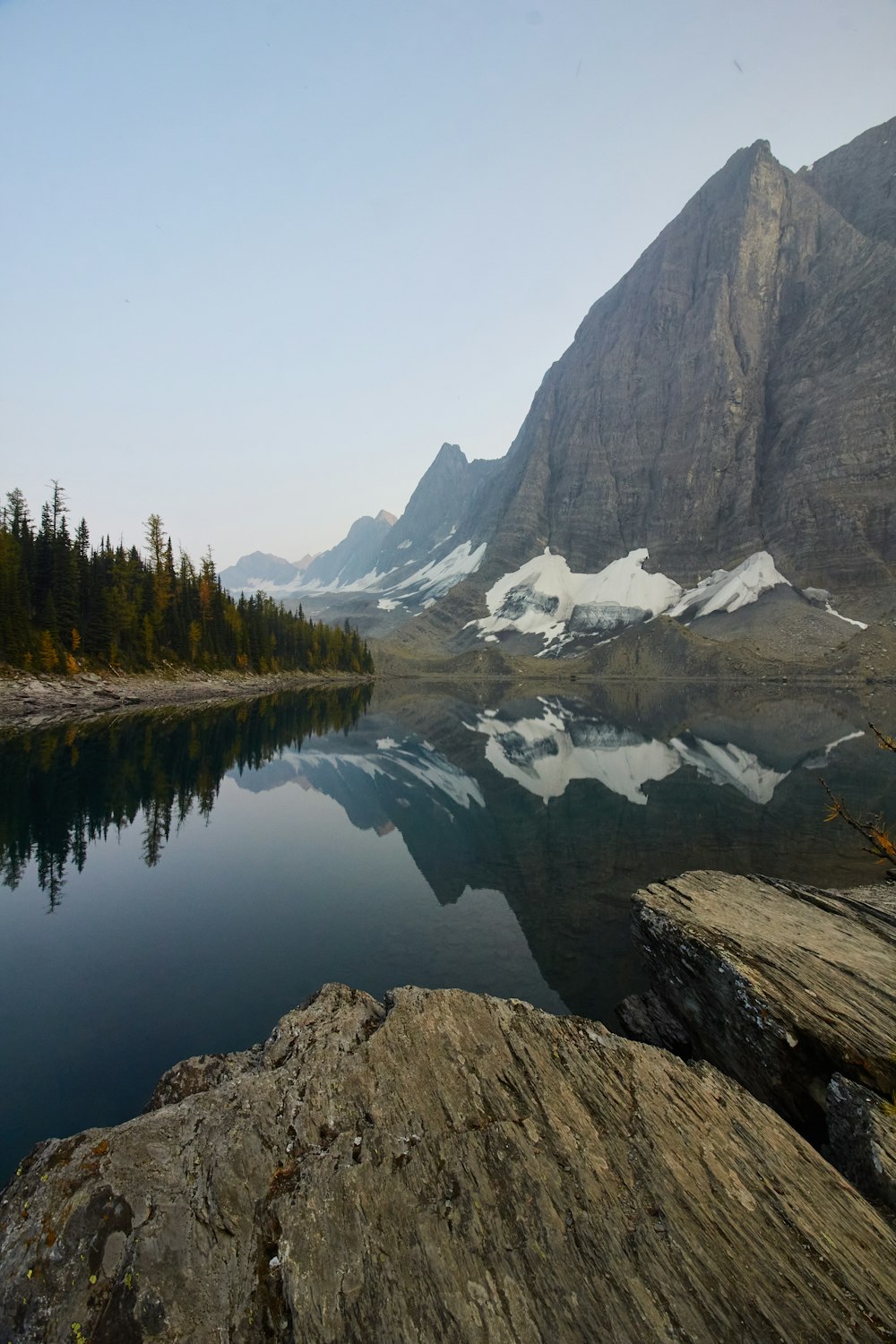 lake near trees and mountain during daytime