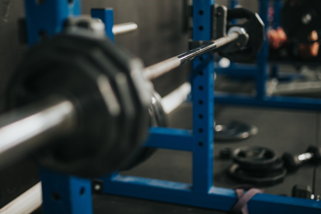 blue and gray dumbbell on blue metal rack