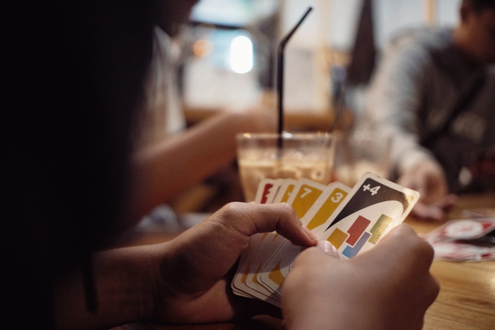 person holding a white and red card