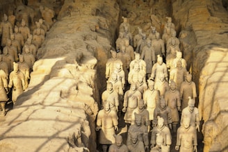 brown stone wall with human face carved