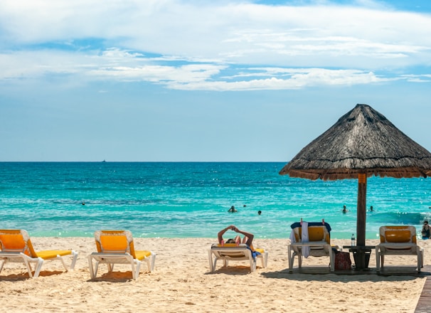 brown beach umbrellas on beach during daytime