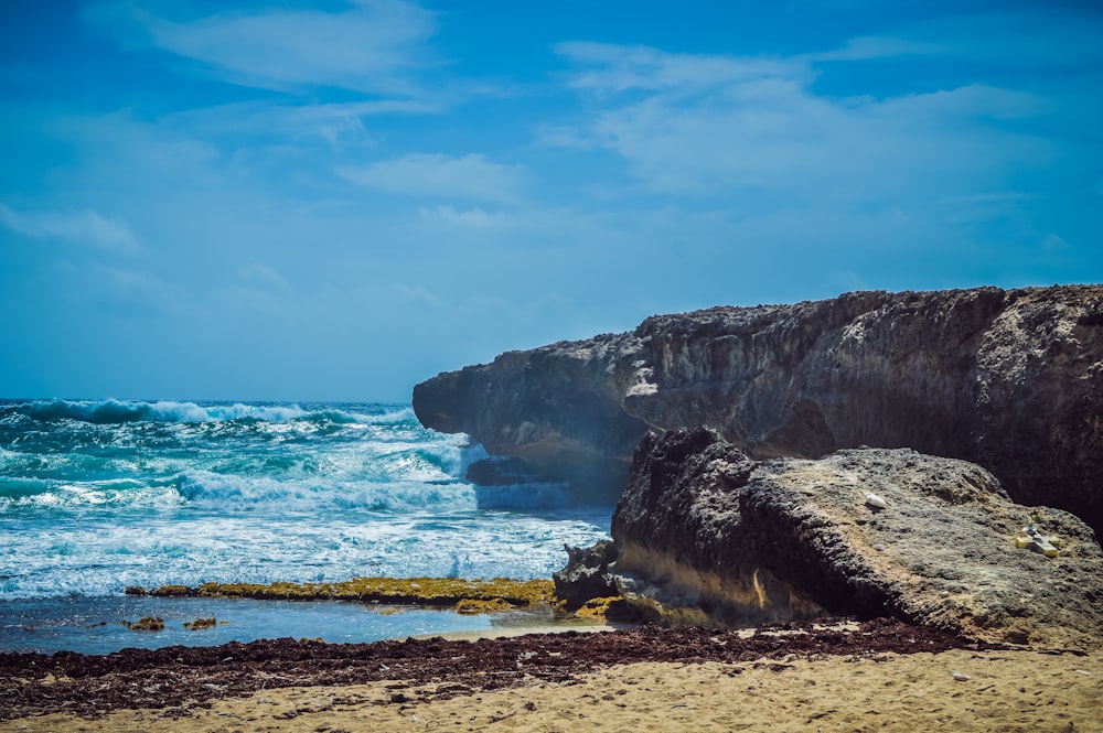 ocean waves crashing on shore during daytime