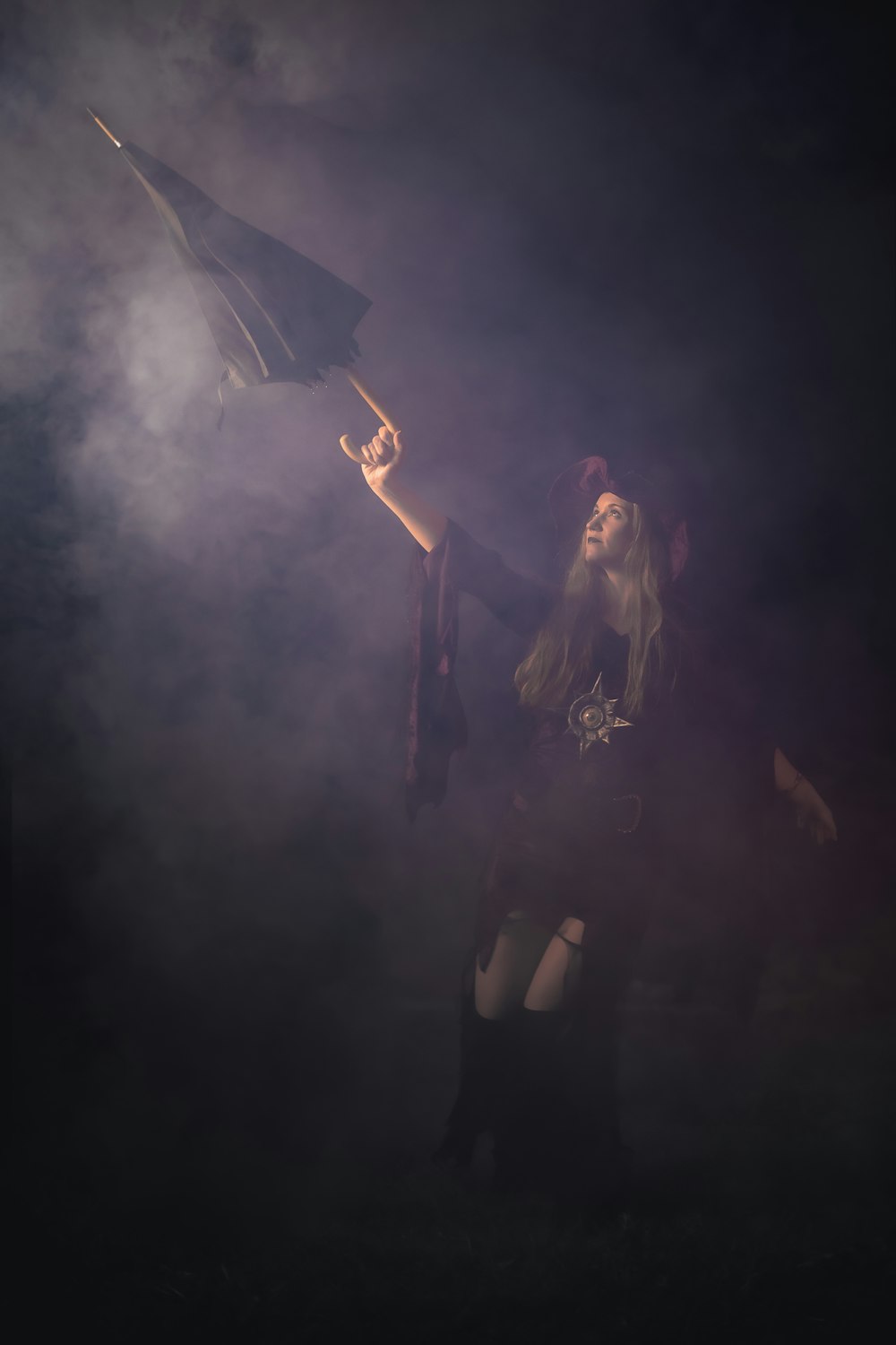 man in black shirt holding black umbrella