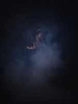 A mysterious figure cloaked in dark fabric.