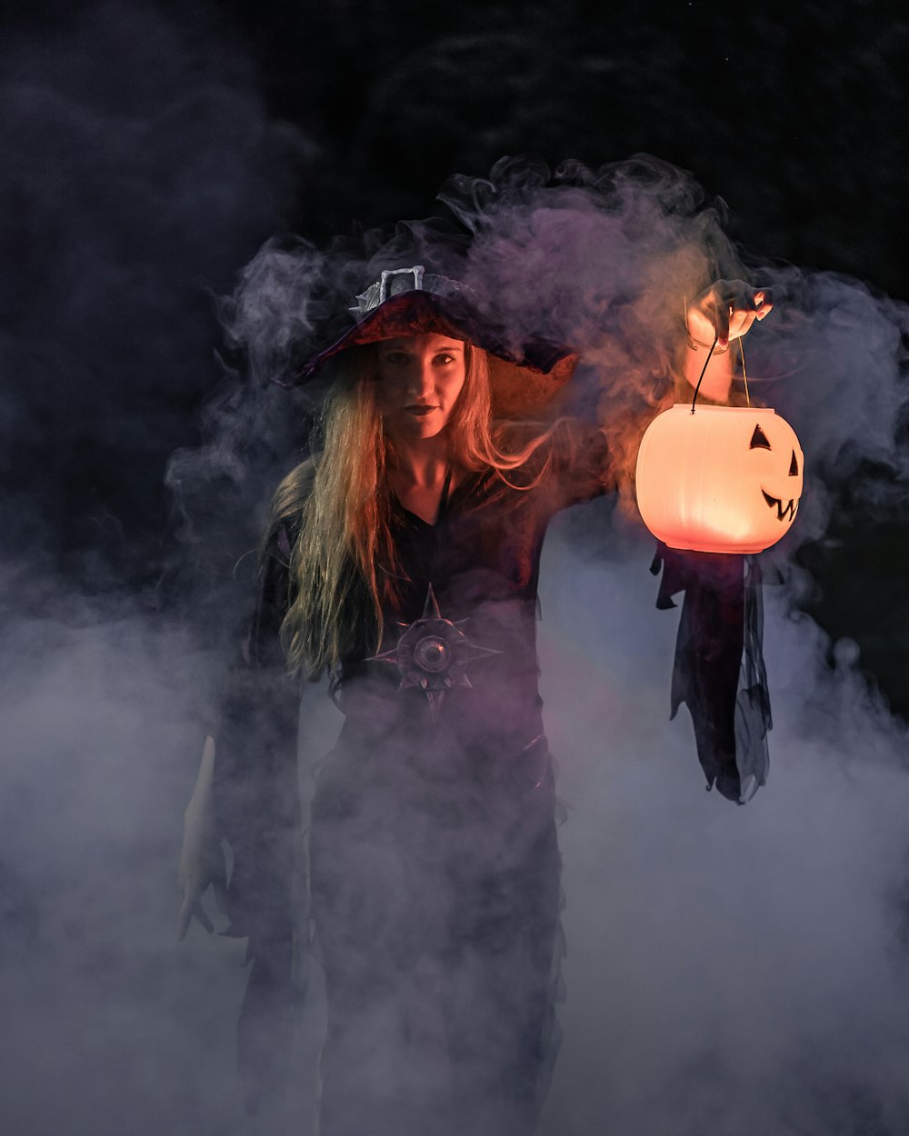 woman in black long sleeve shirt holding jack o lantern