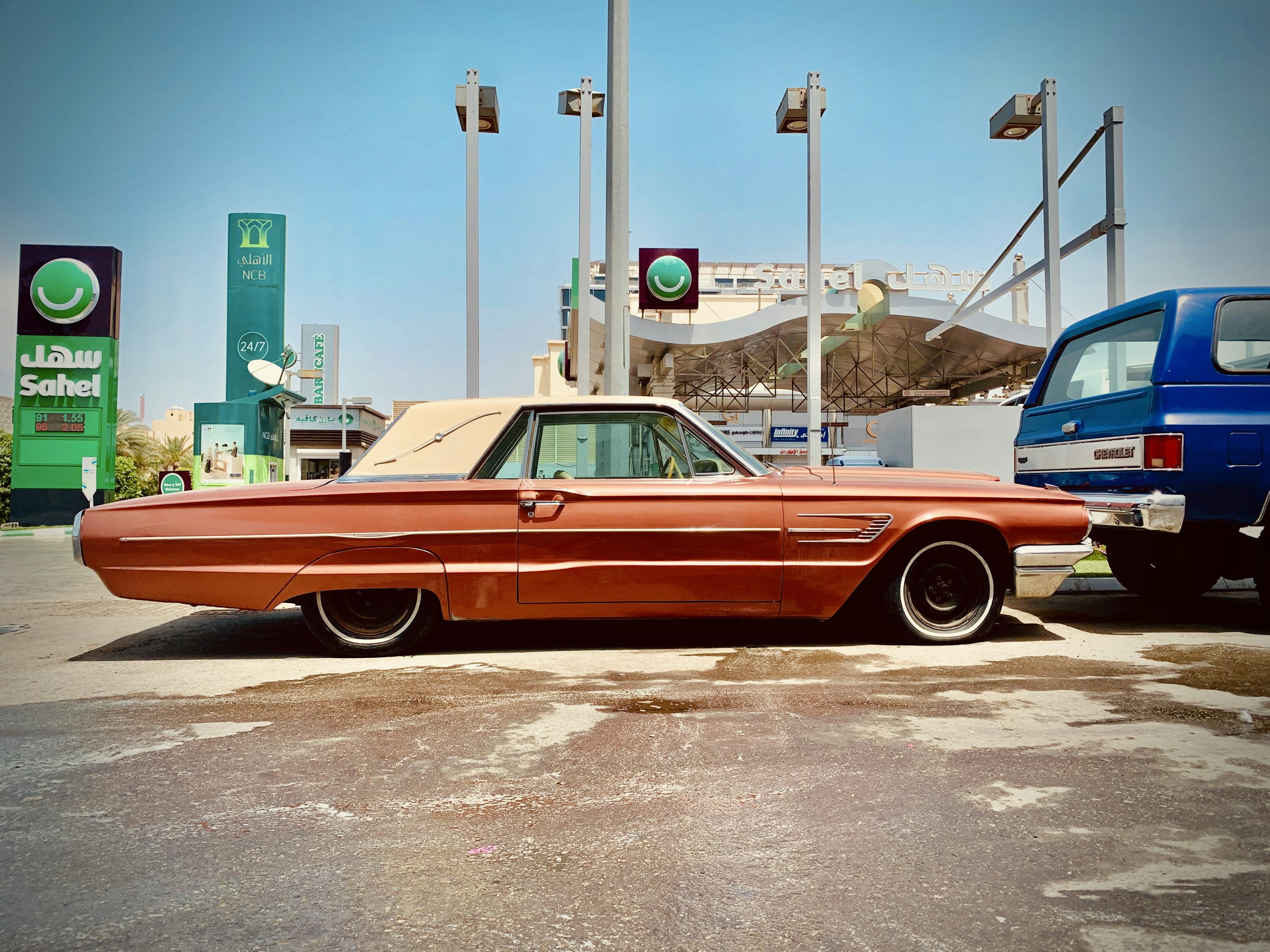 brown and white vintage car on road during daytime