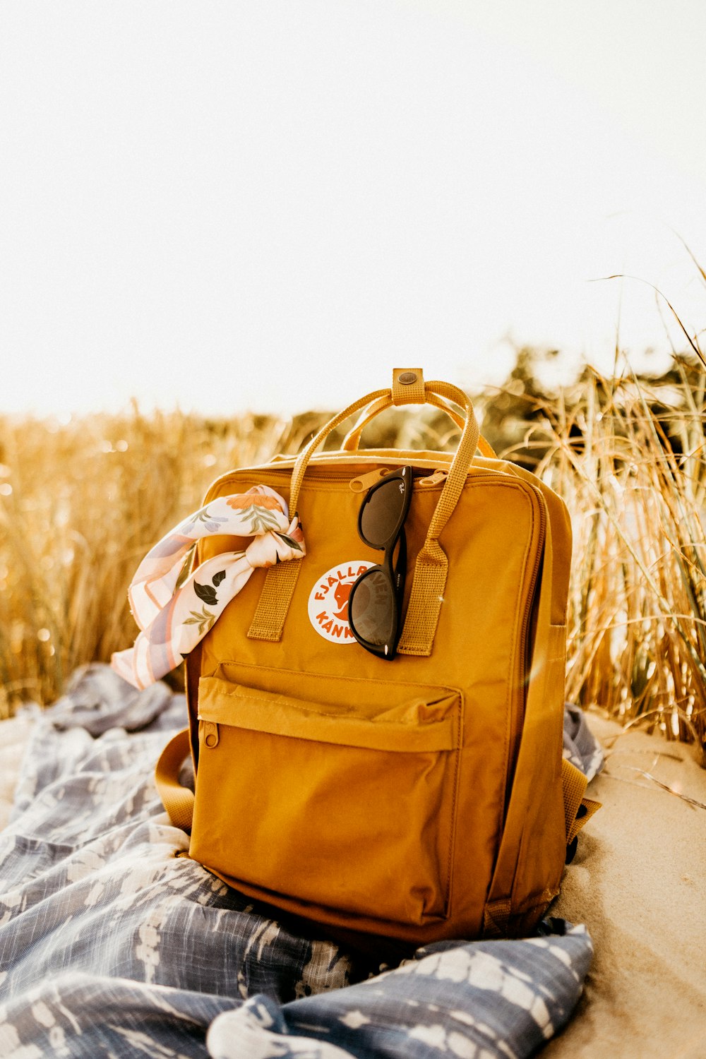 brown leather backpack on snow covered ground during daytime