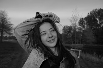 Youth leading a community clean-up event, planting trees and smiling.