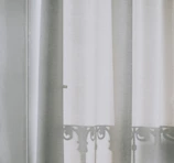 Soft mesh balcony curtains gently swaying in the breeze.