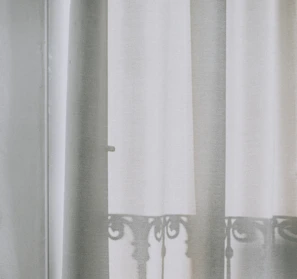 Soft mesh balcony curtains gently swaying in the breeze.