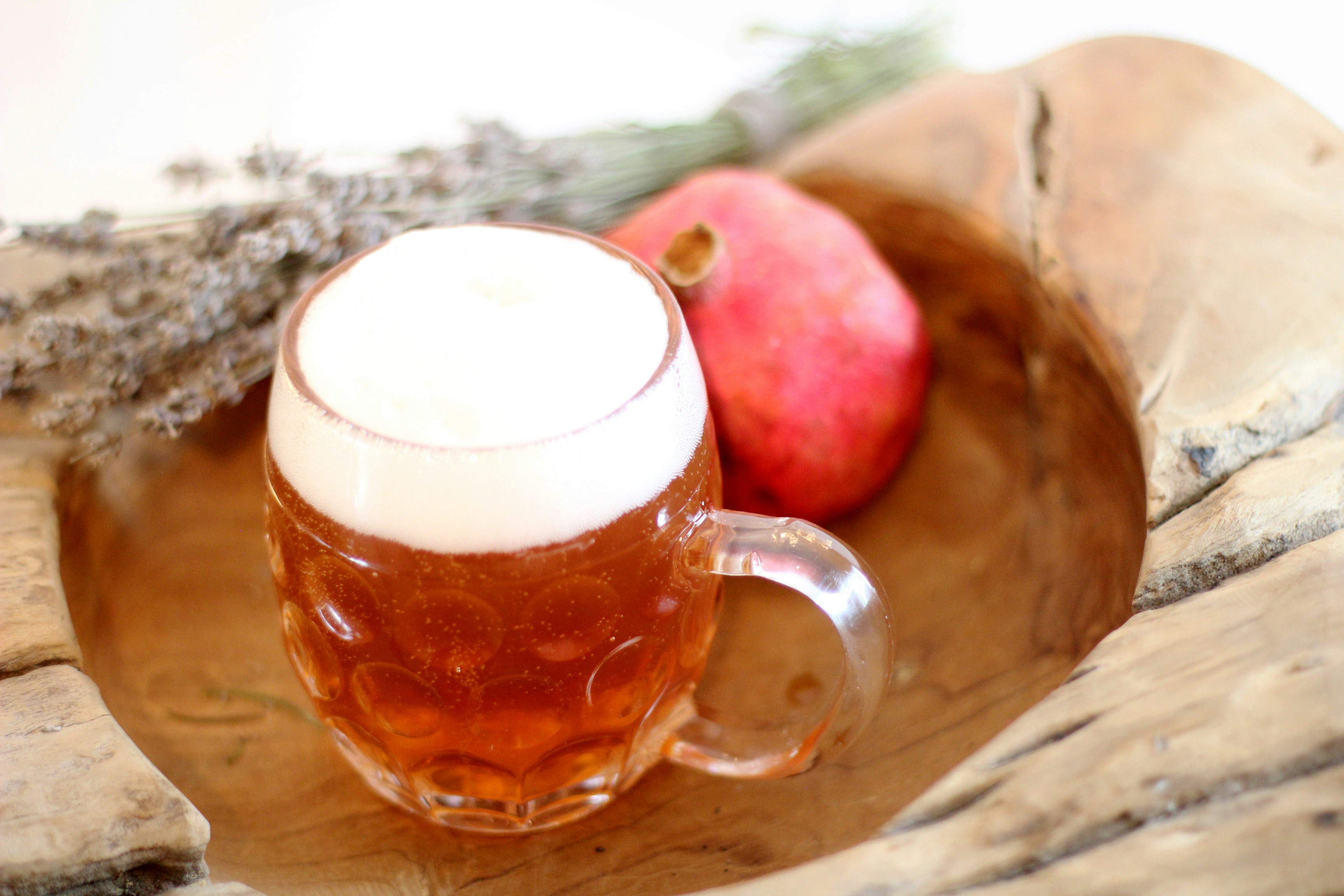 Mug of cider with a pomegranate