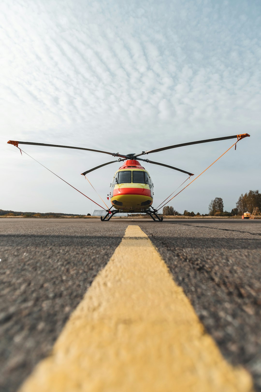 red and white helicopter on the field