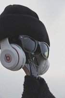 Side view of a musician tuning their guitar, wearing Dream Fit Monitor headphones.