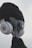 A creative visual of a guitar headstock dressed up with a hat, sunglasses, and headphones, giving it a human-like appearance.