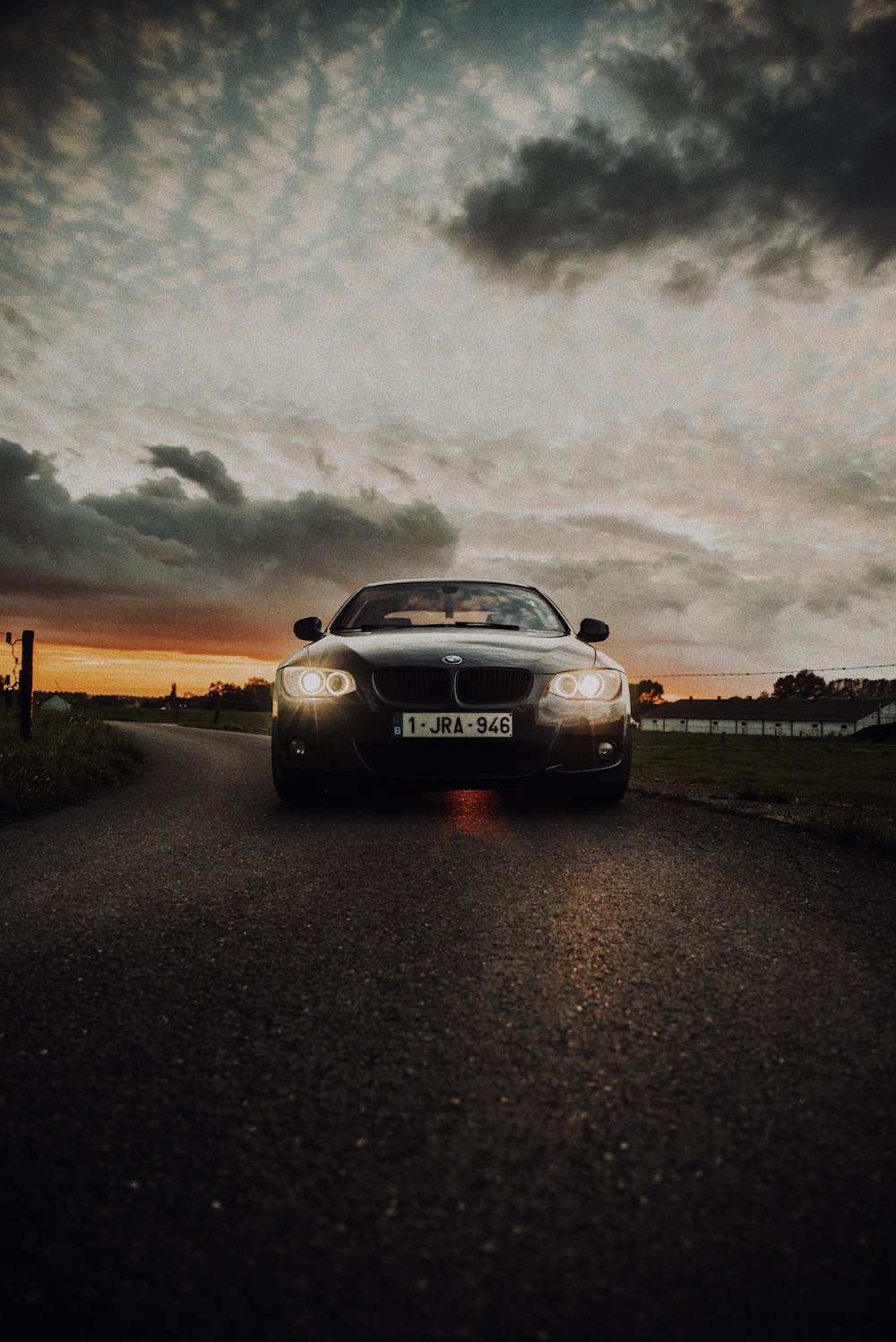 black porsche 911 on road under gray clouds