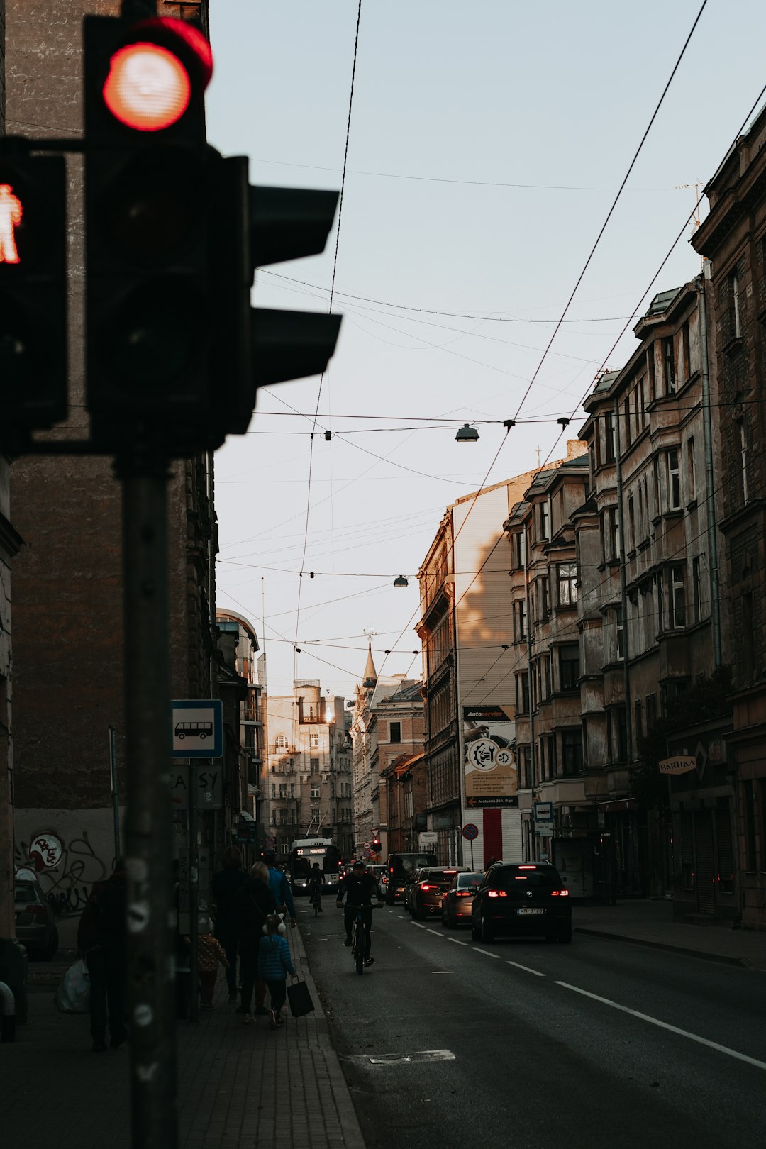 cars on road in between buildings during daytime