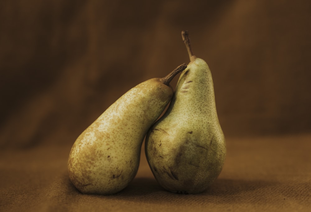 two green and yellow pear fruits