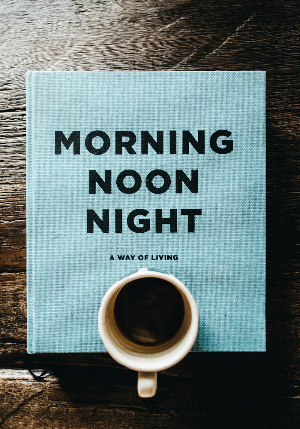 a book with a cup of coffee on top of it