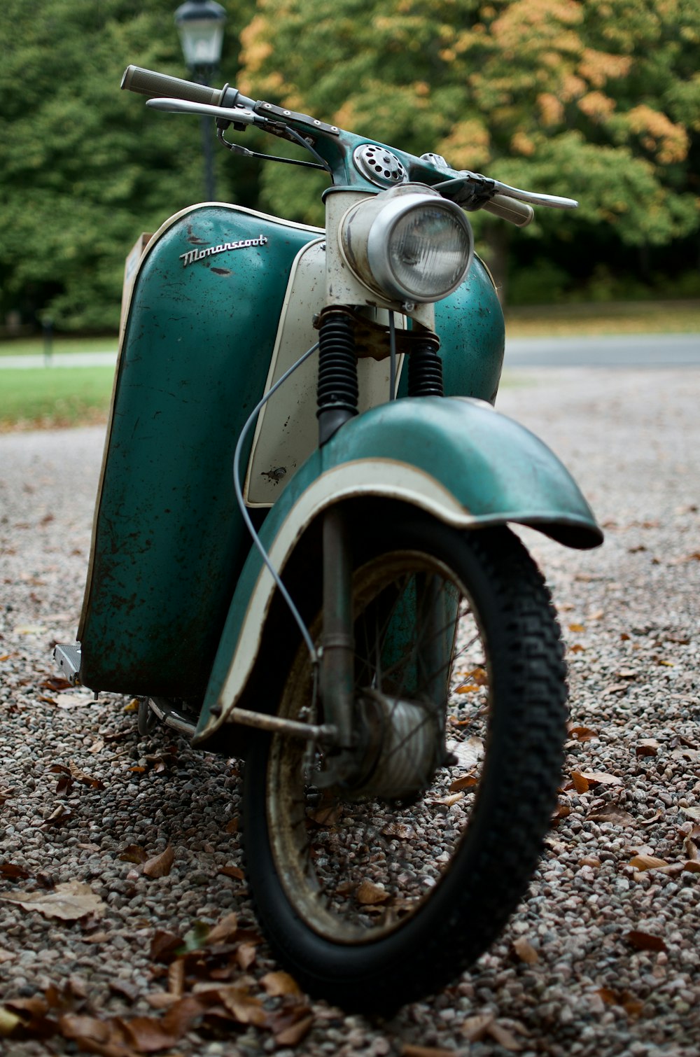 green and white motorcycle on green grass field during daytime