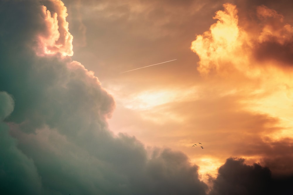 airplane flying over white clouds during daytime