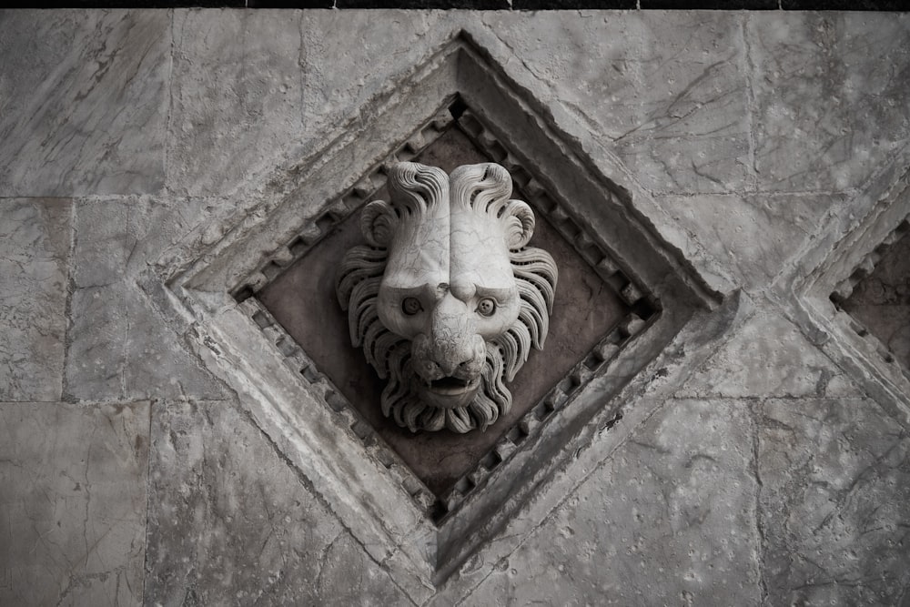 brown concrete wall with human face carved