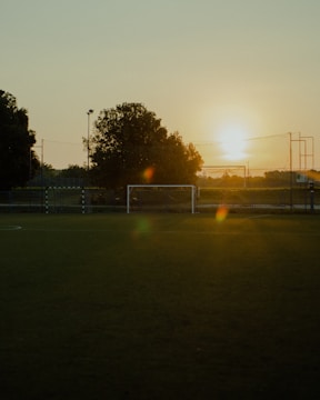 A vibrant image of a soccer field at sunset.